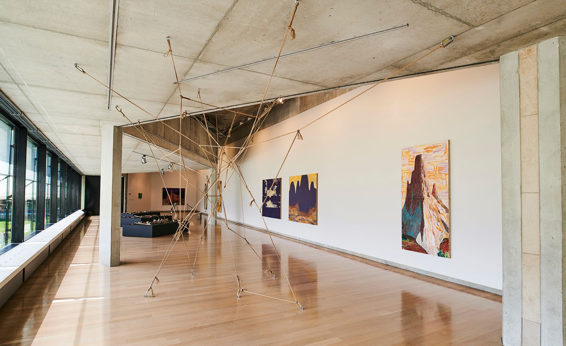 Modern art exhibition inside the Kabuso Art House, showcasing sculpture and paintings.