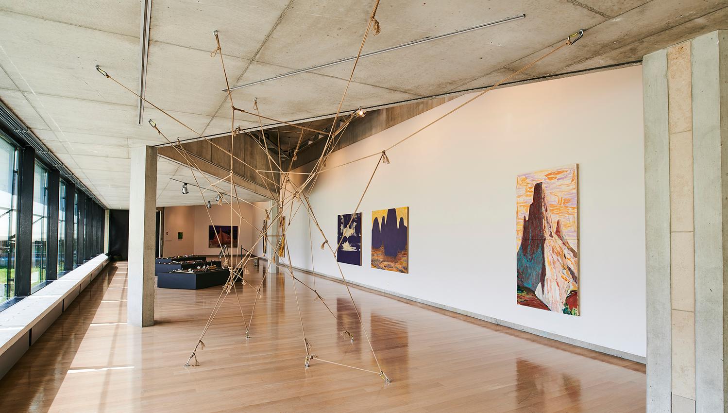 Modern art exhibition inside the Kabuso Art House, showcasing sculpture and paintings.