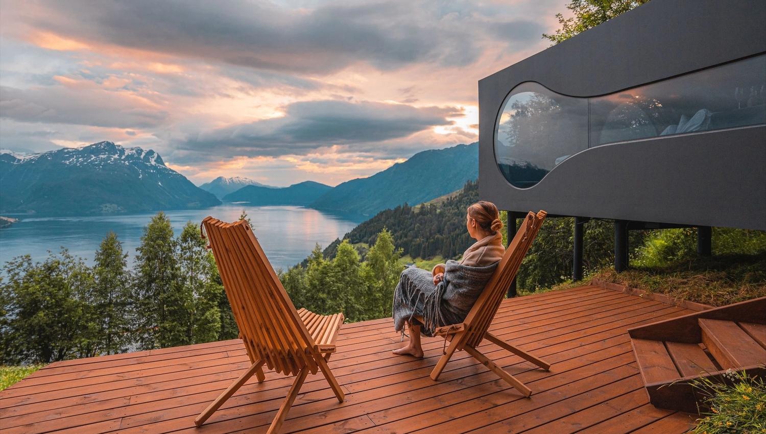 Stunning panoramic view from the Birdbox cabin at Skaara Living on Lotsberg in Nordfjord, surrounded by mountains and fjord landscape.