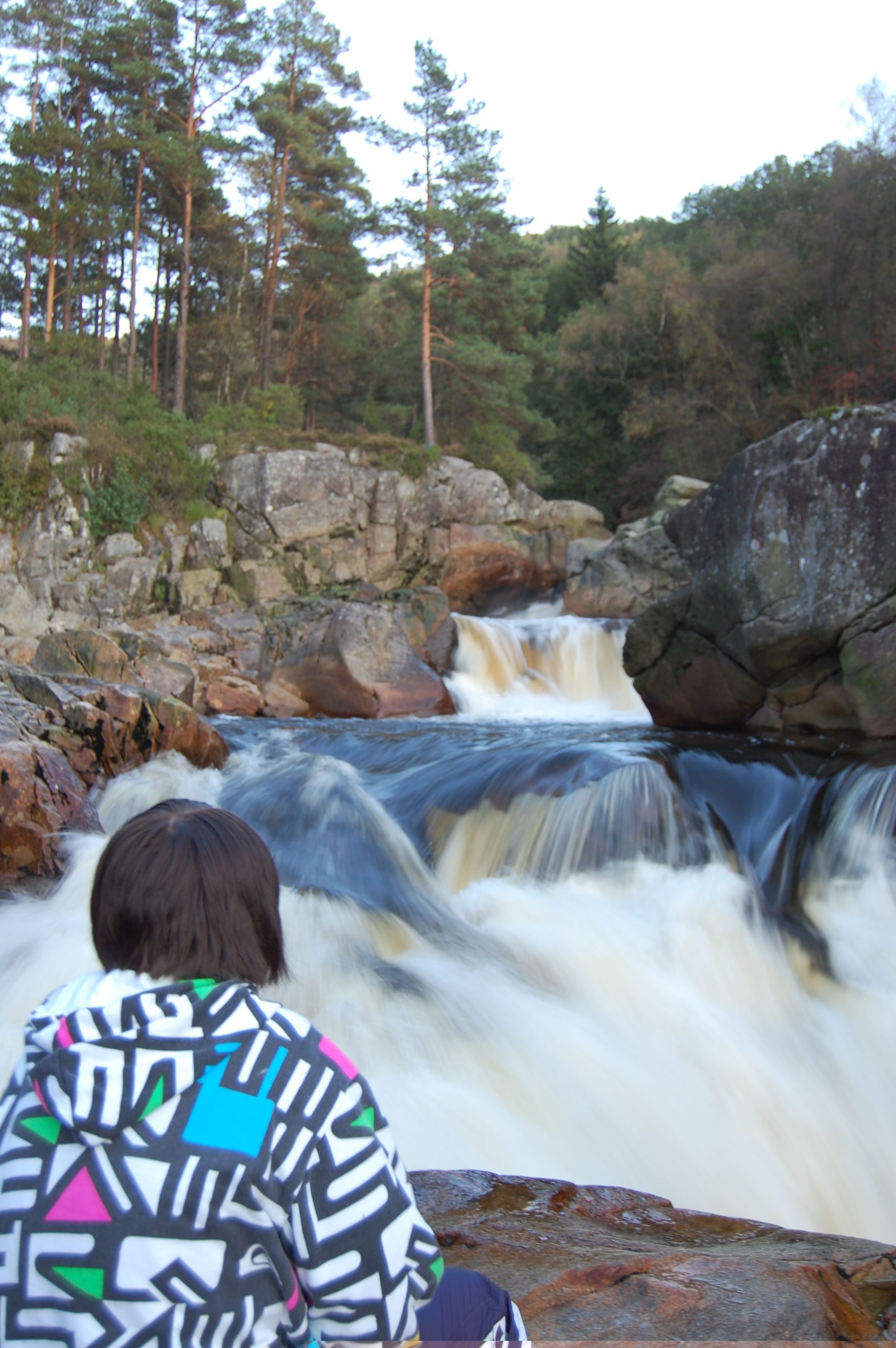 A woman looking at a waterfall