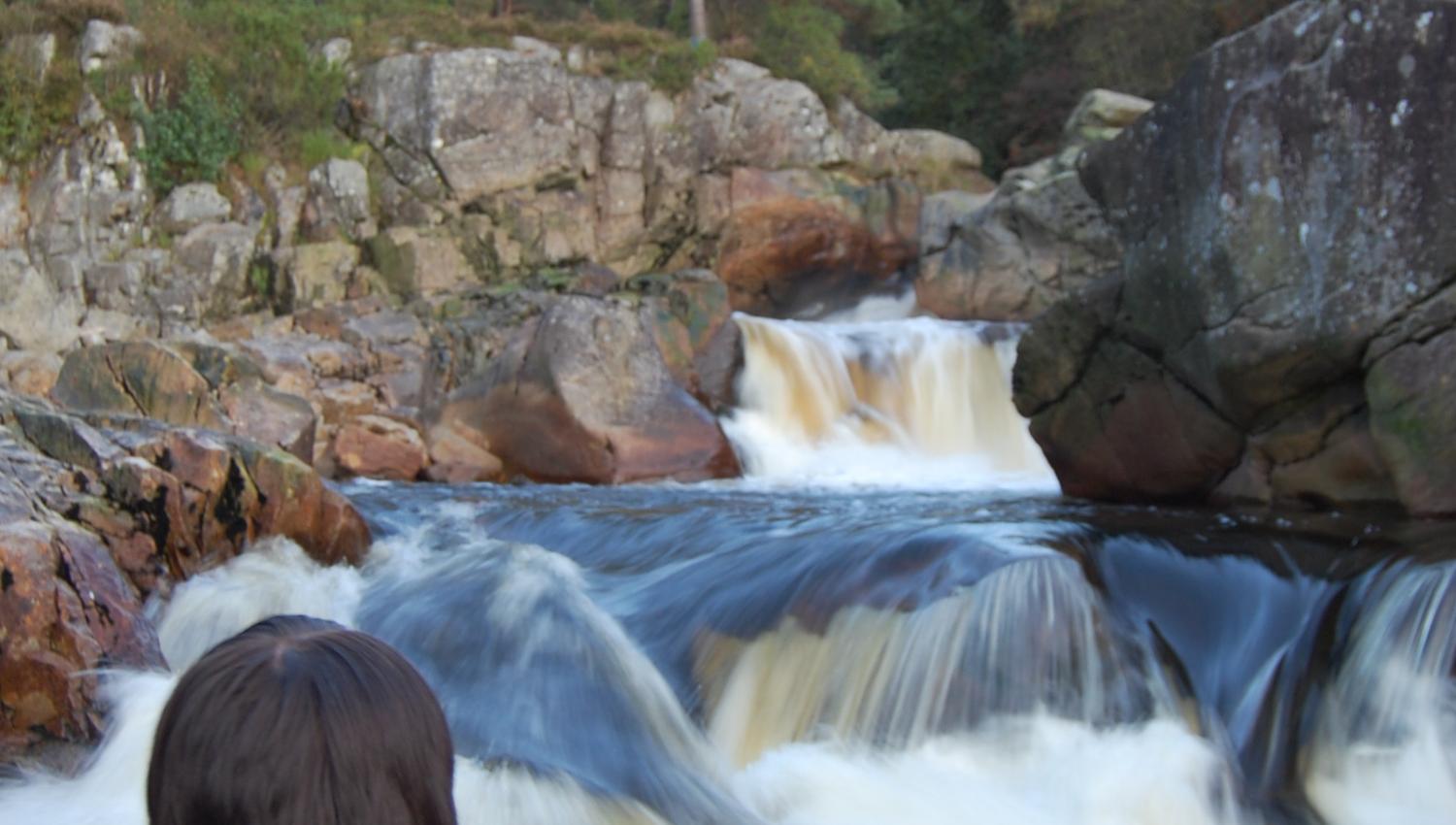 A woman looking at a waterfall
