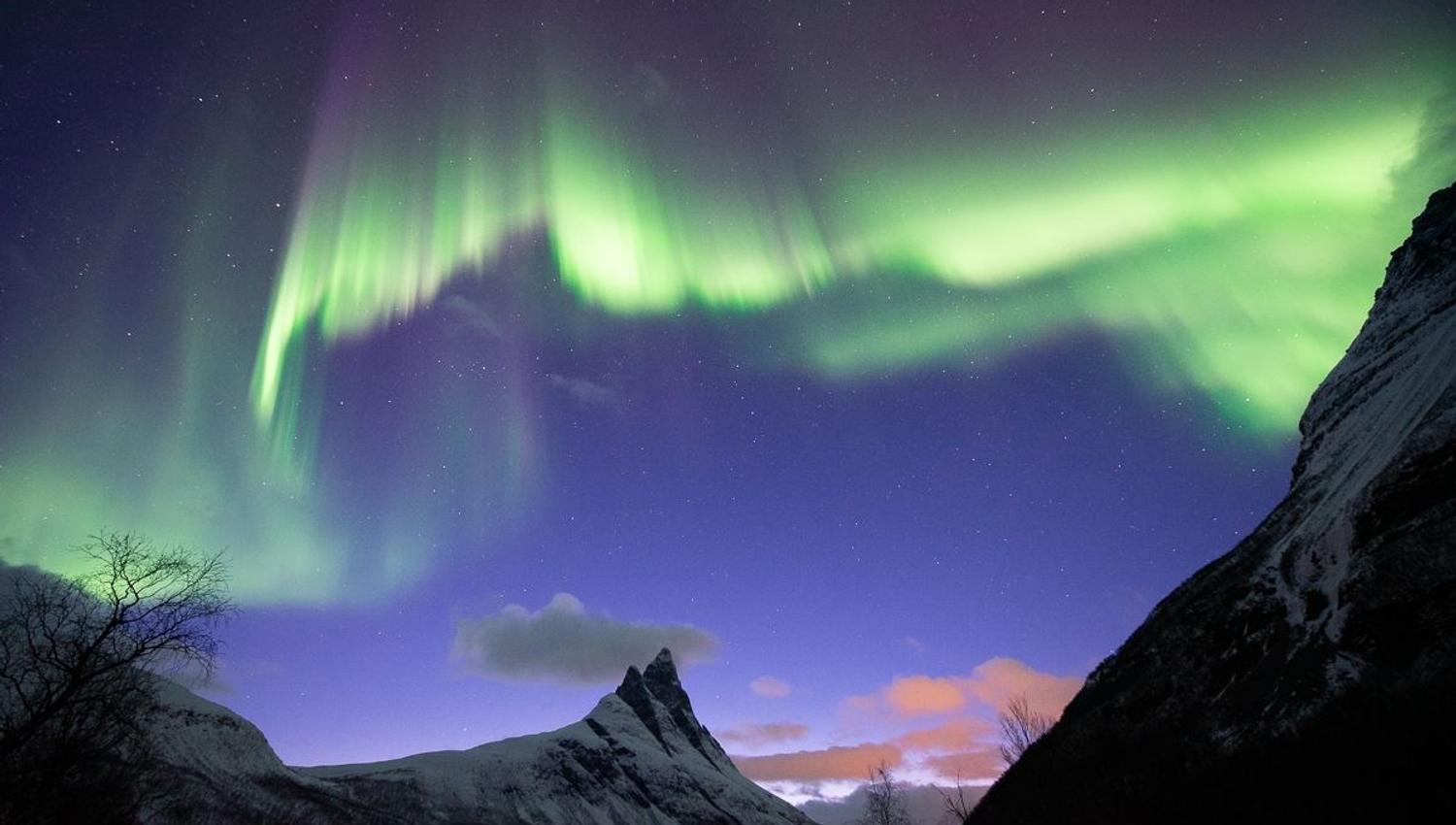 Northern Lights form a crooked and unique line over the Otertind mountain