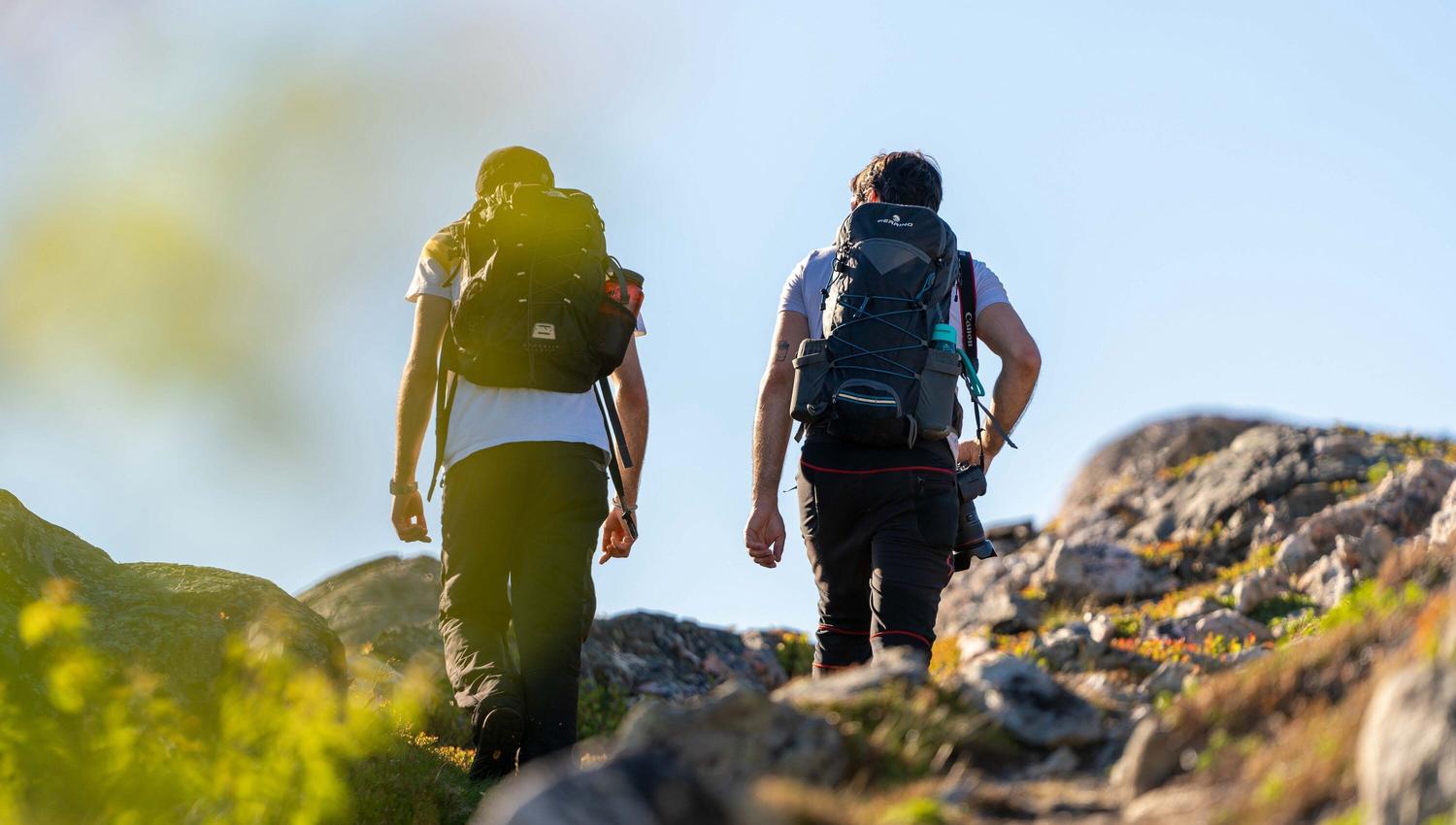 two people hiking up the hill on Hillesøy