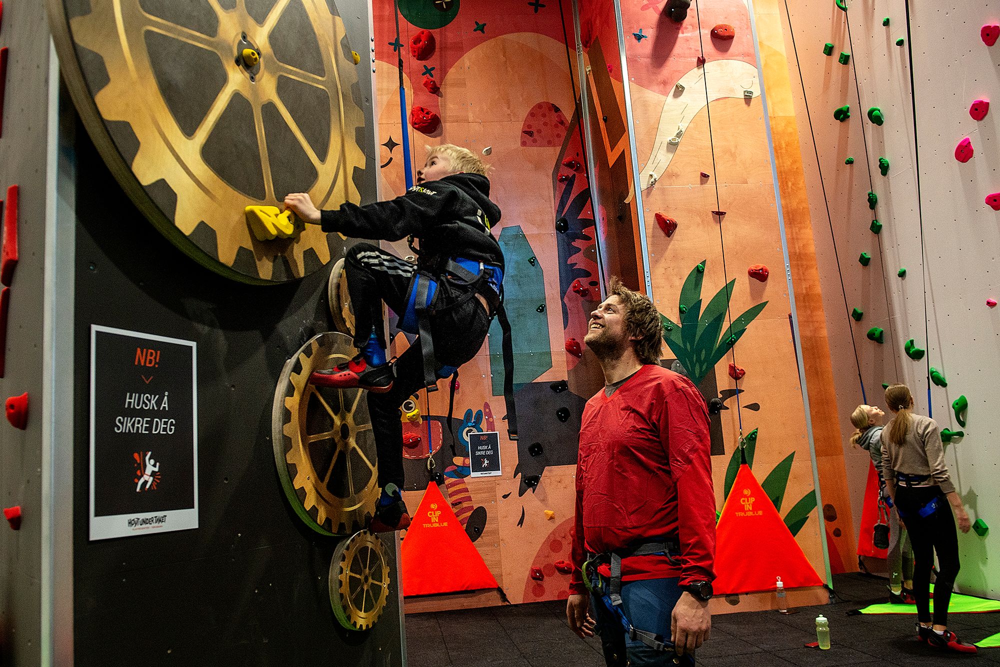 Children climb and the adult looks after