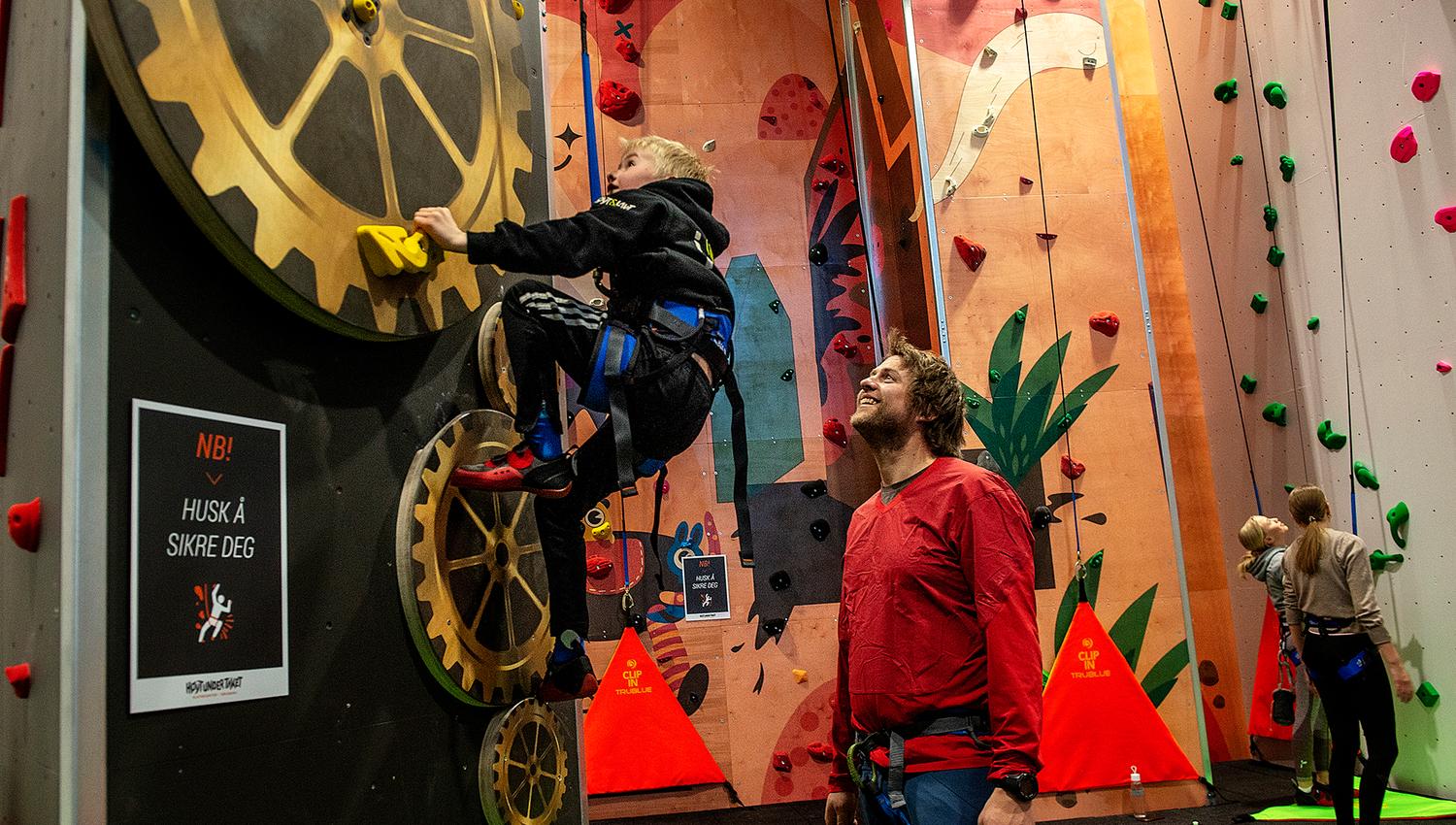 Children climb and the adult looks after