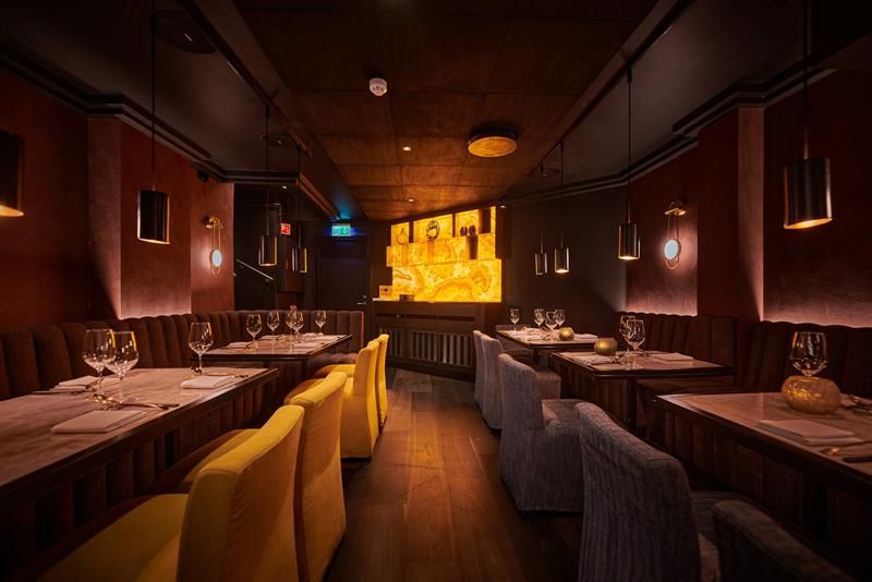 Yellow and brown chairs and tables set for dining