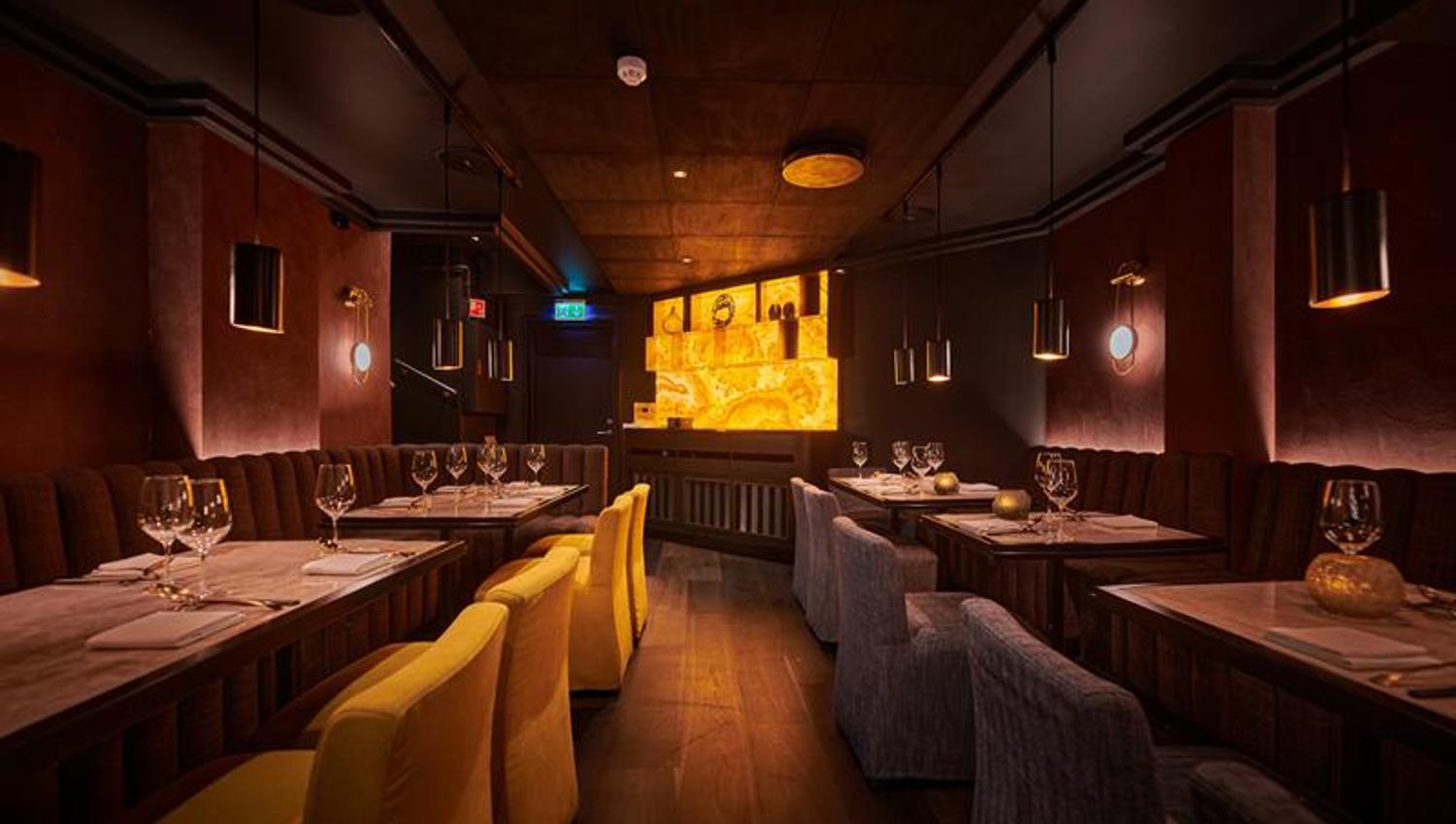 Yellow and brown chairs and tables set for dining
