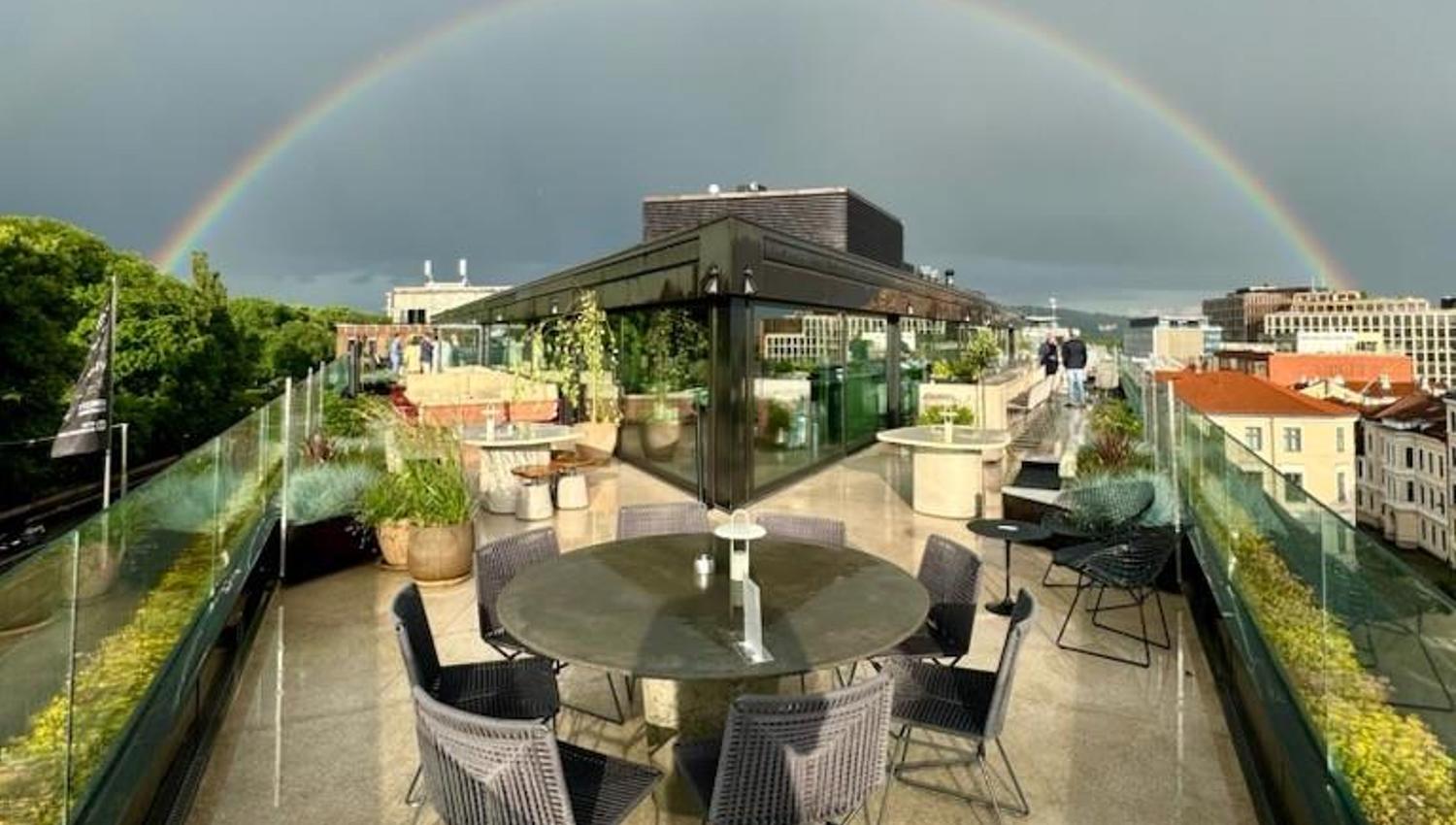 Roof terrace with a rainbow across the sky