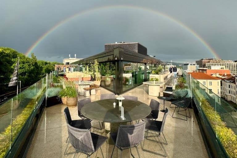 Roof terrace with a rainbow across the sky