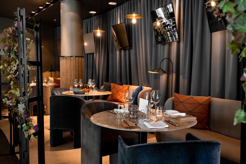 Seating sections next to small round tables.