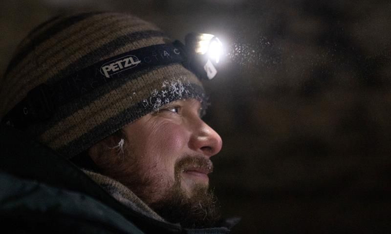 Portrait of a man with head lamp