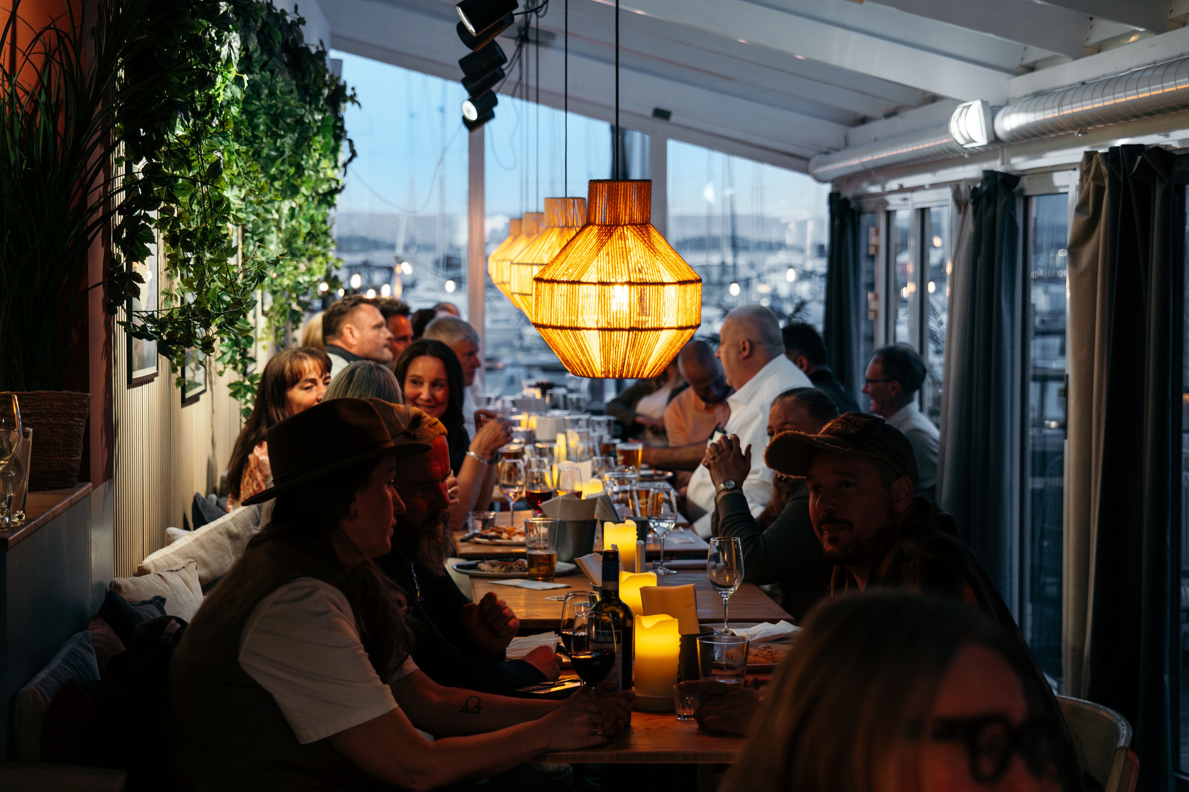 Happy guest seated by the table