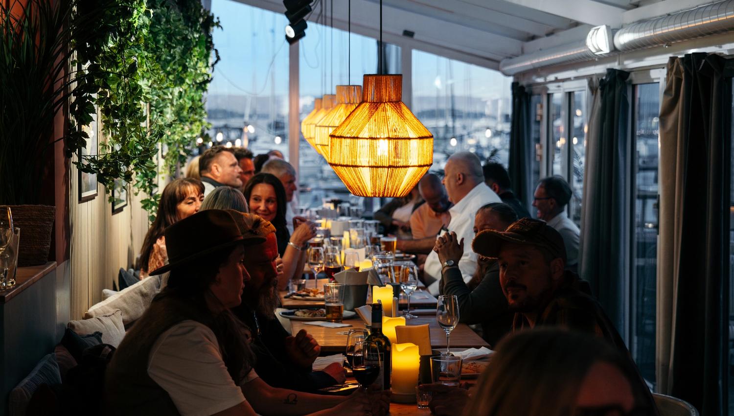 Happy guest seated by the table