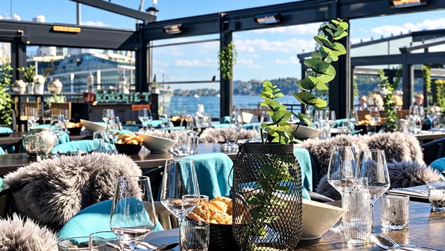 Outdoor seating at Kokeriet Restaurant in Sandefjord with set tables by the waterfront.
