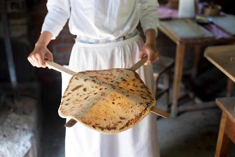 Newly baked pancake on wooden sticks. Norwegian Museum of Cultural History