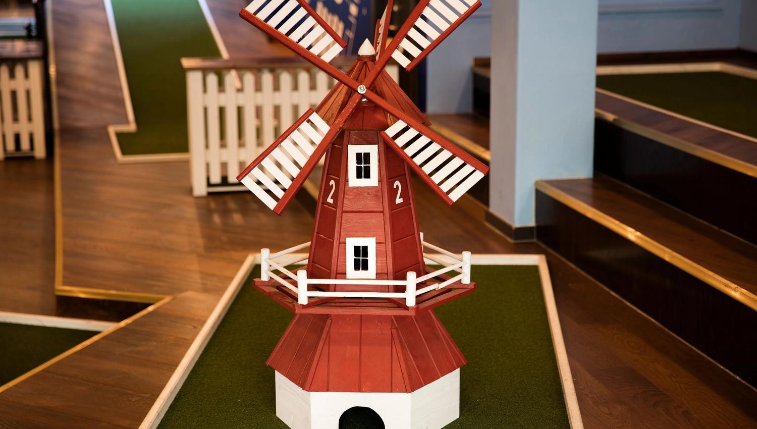 hole in the miniature golf course with a miniature windmill on