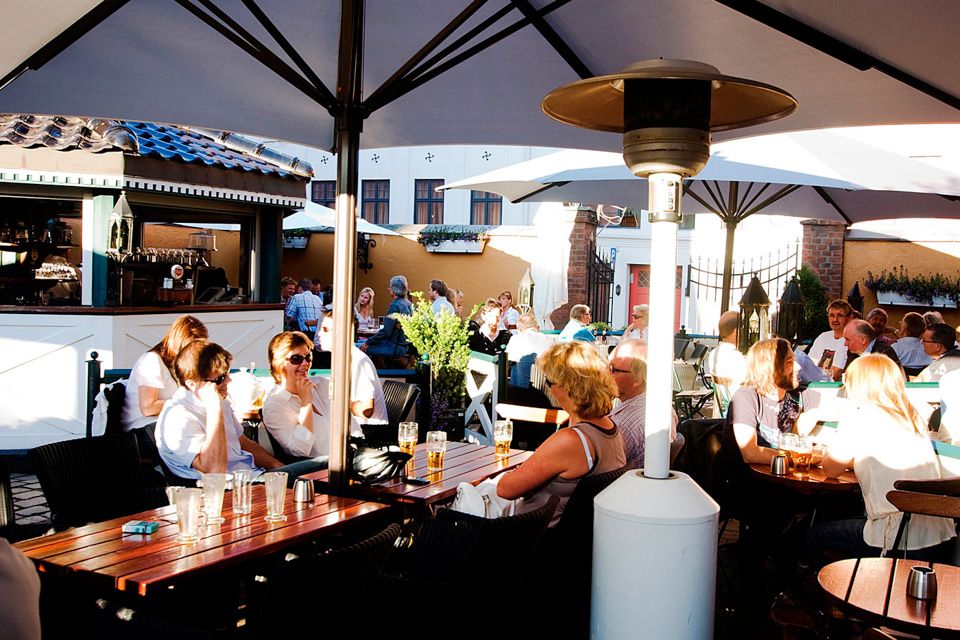 Outdoor seating underneath parasols.