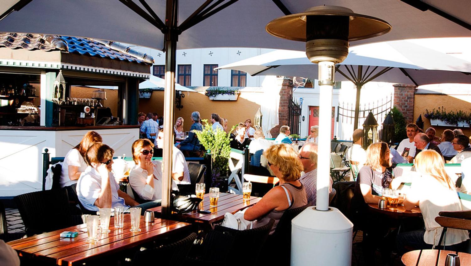 Outdoor seating underneath parasols.