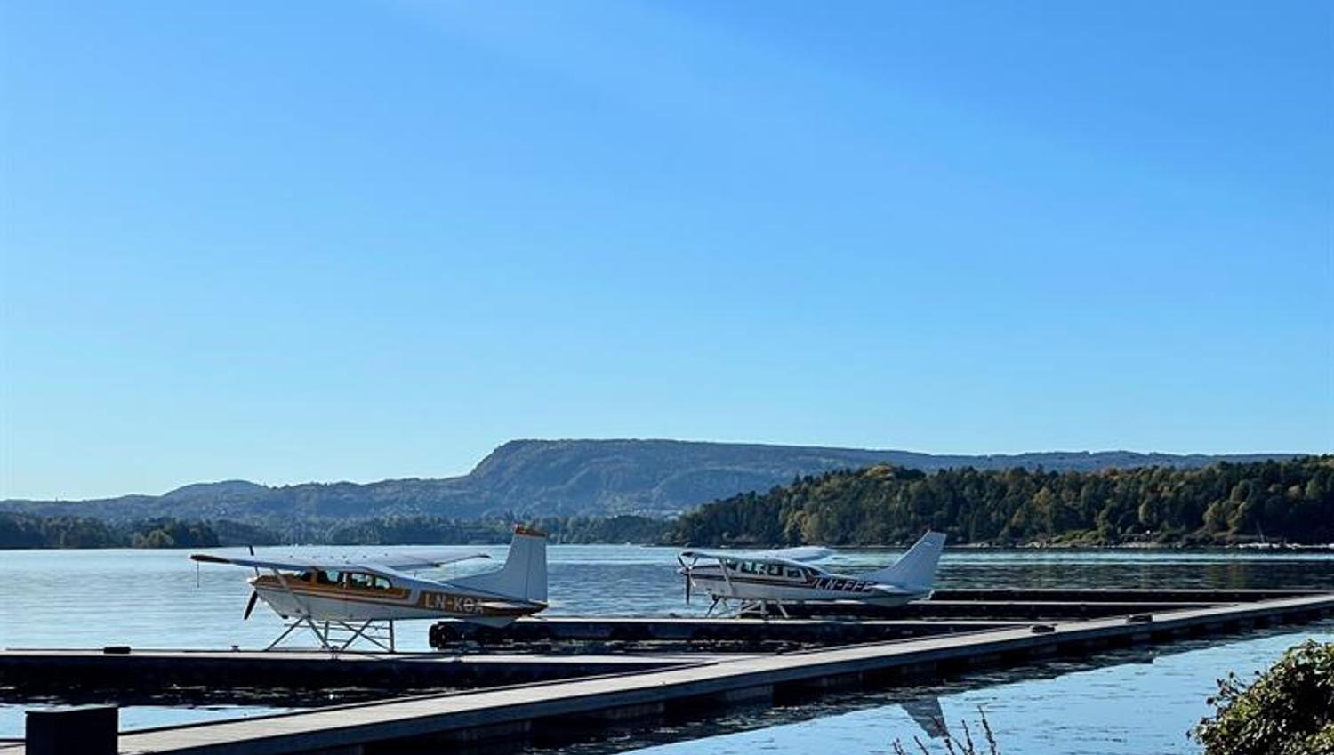 Two sea planes by the dock