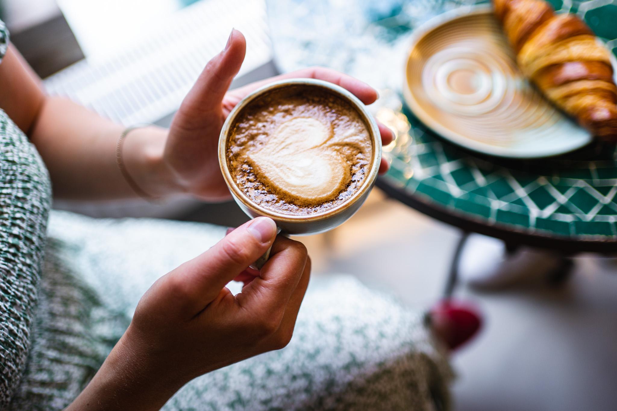 a woman holding a coffee cup 