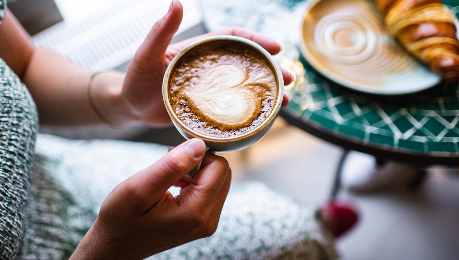 a woman holding a coffee cup