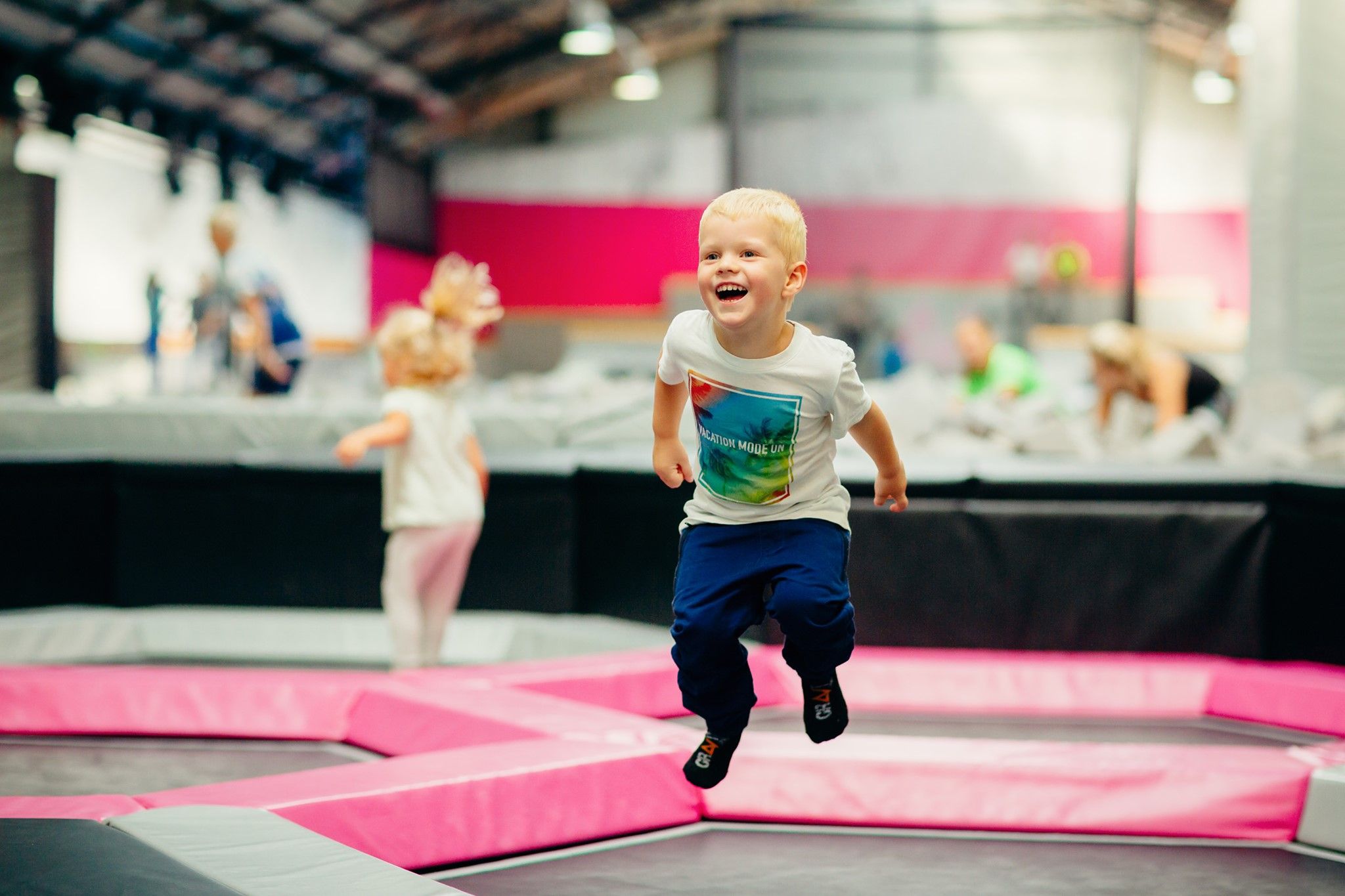 En liten gutt hopper på trampoline