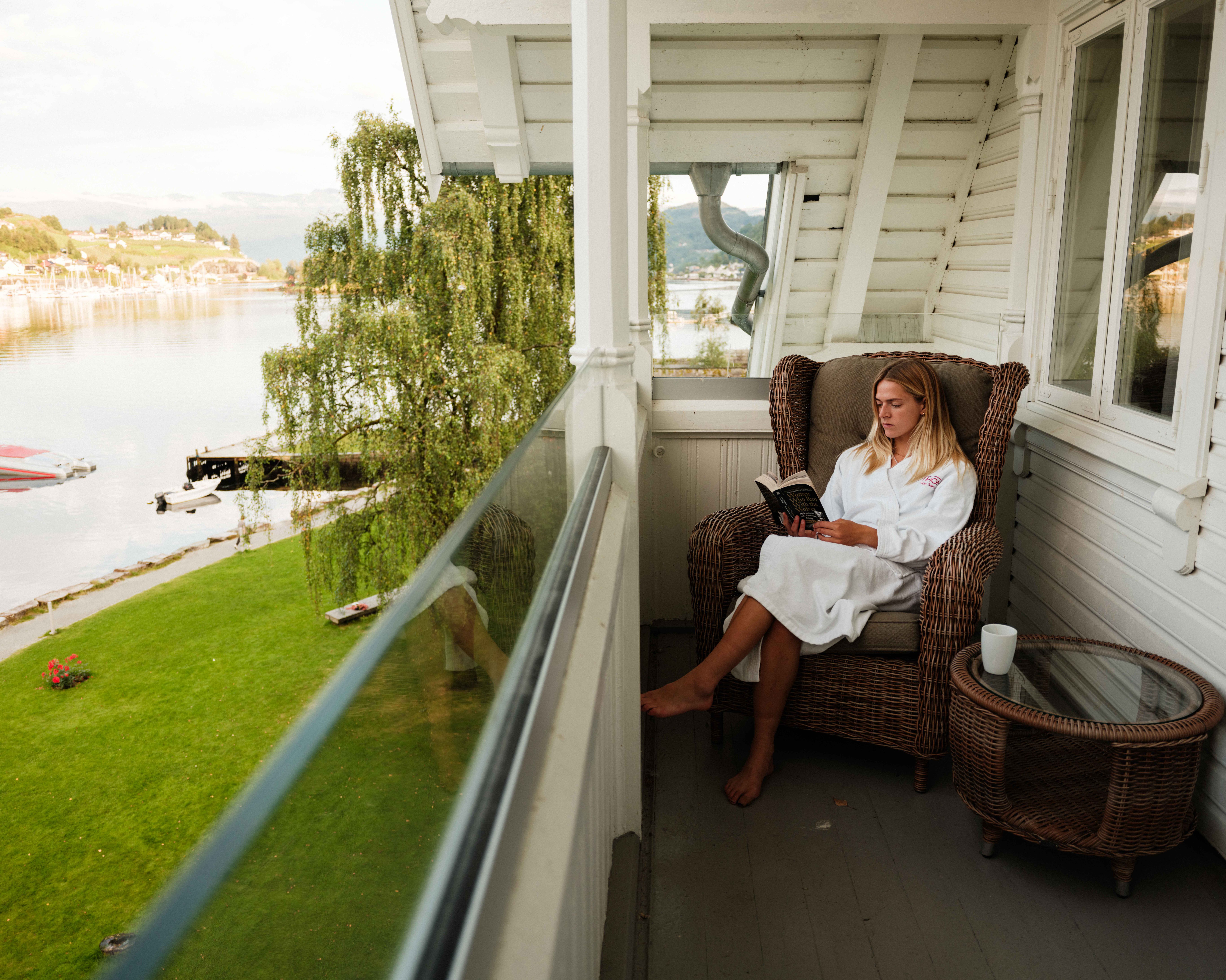 Relaxing on the balcony with a fjord view at Thon Hotel Sandven – a tranquil morning by the Hardangerfjord.