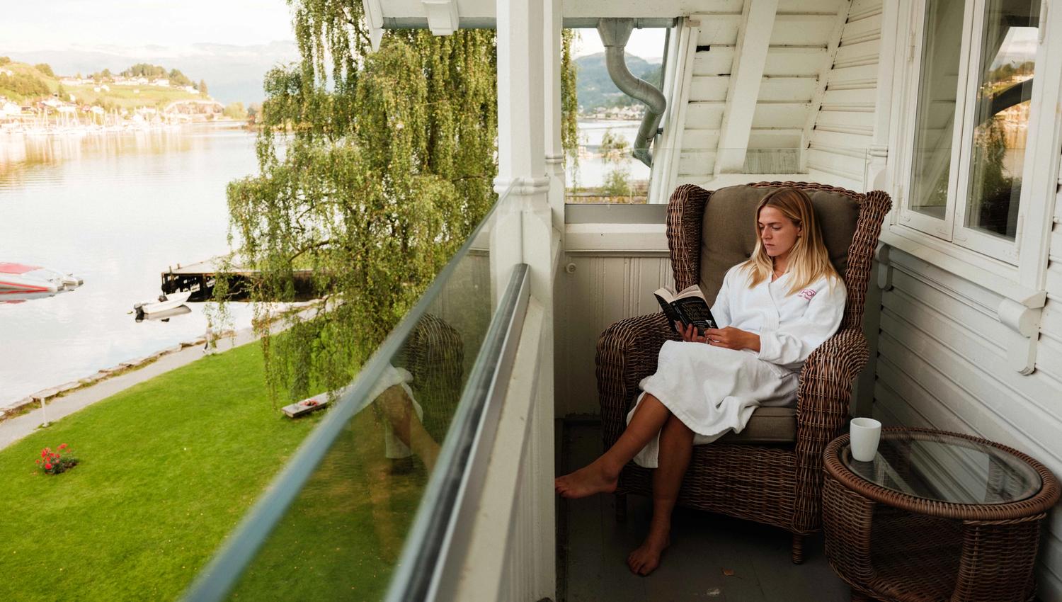 Relaxing on the balcony with a fjord view at Thon Hotel Sandven – a tranquil morning by the Hardangerfjord.