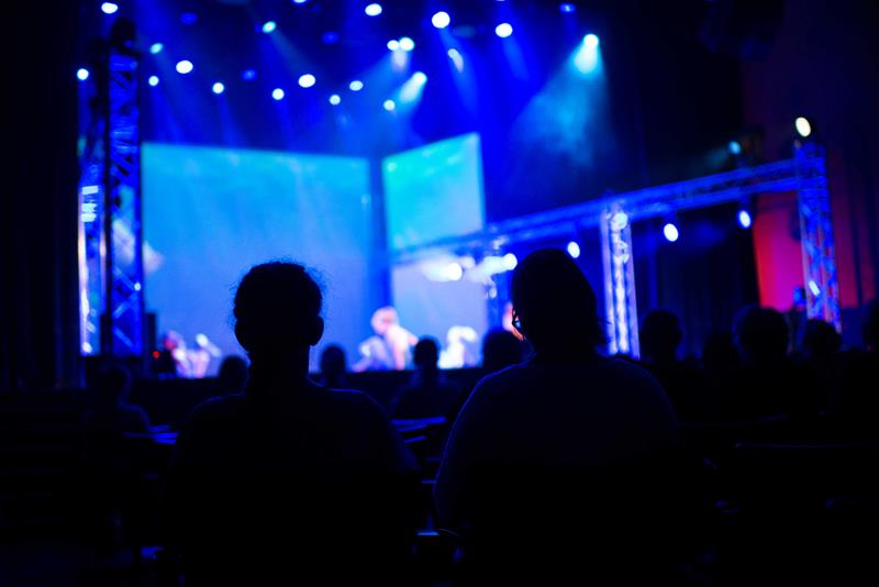 concert with blue lights on stage