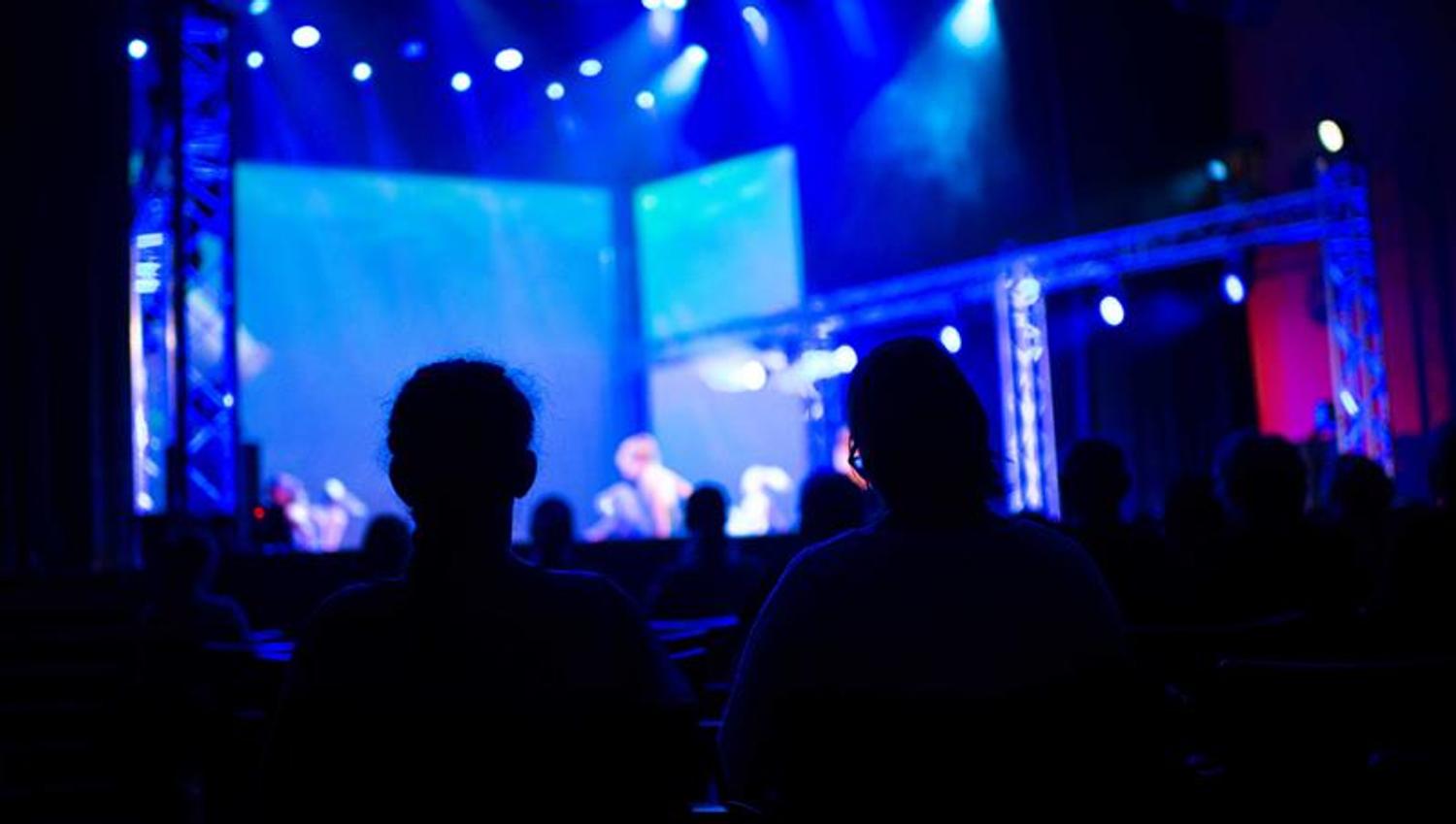 concert with blue lights on stage