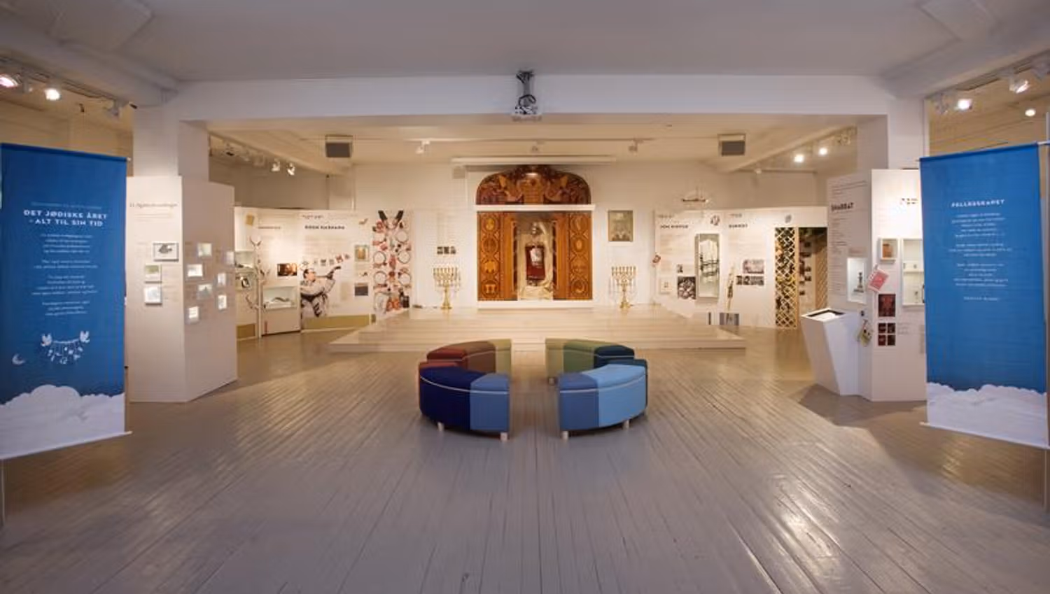Interior. Posters along the walls, seating section in the middle of the room.