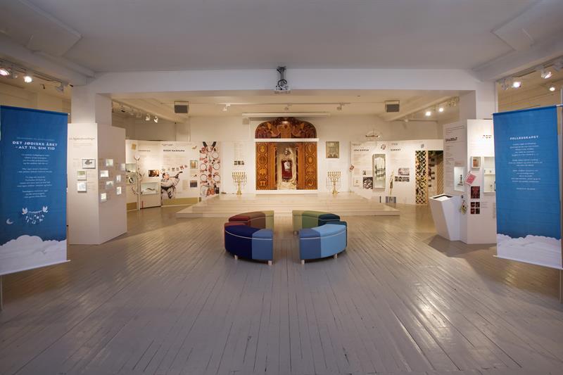 Interior. Posters along the walls, seating section in the middle of the room.