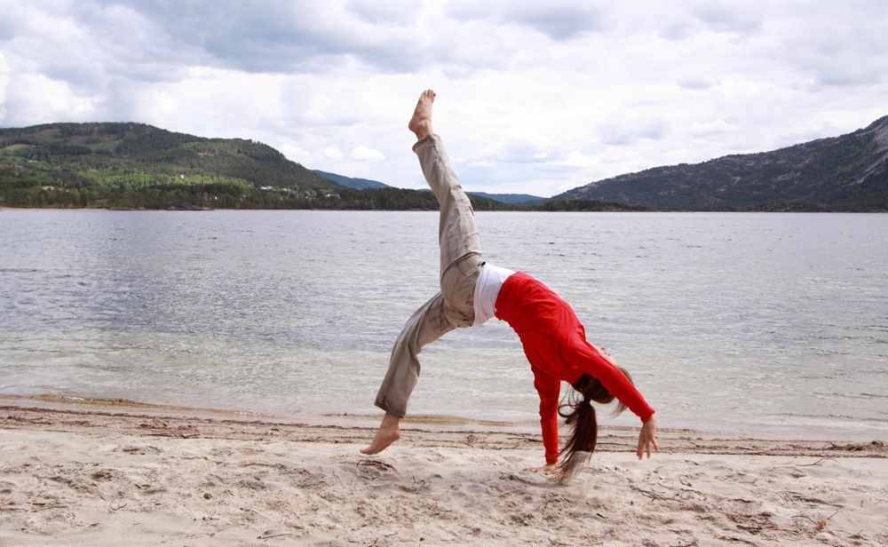 girl doing yoga on the beach