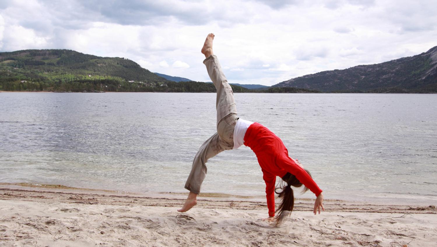 girl doing yoga on the beach
