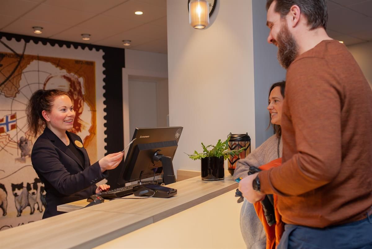 Guest receiving assistance at the reception desk.