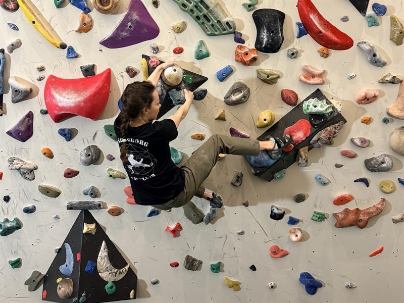 one person climbing at a boulder wall
