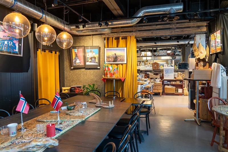 Interior: Long table with Norwegian flags and lights, round glass lamps in the ceiling and pictures on the walls