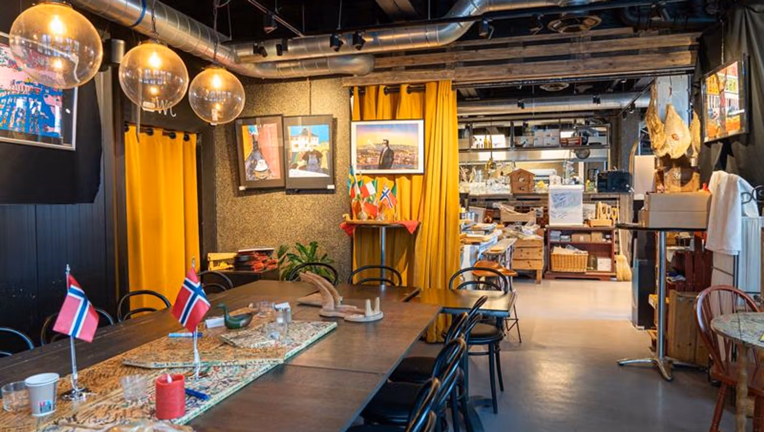 Interior: Long table with Norwegian flags and lights, round glass lamps in the ceiling and pictures on the walls