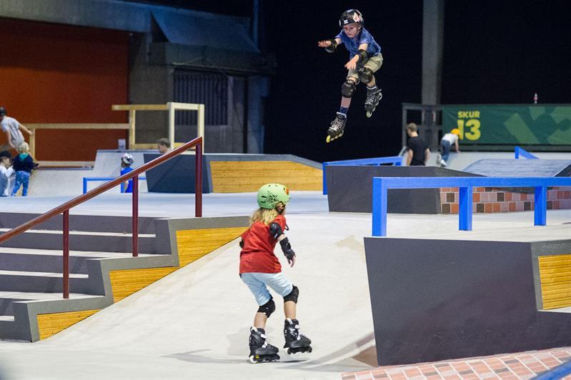 children on roller skates indoors