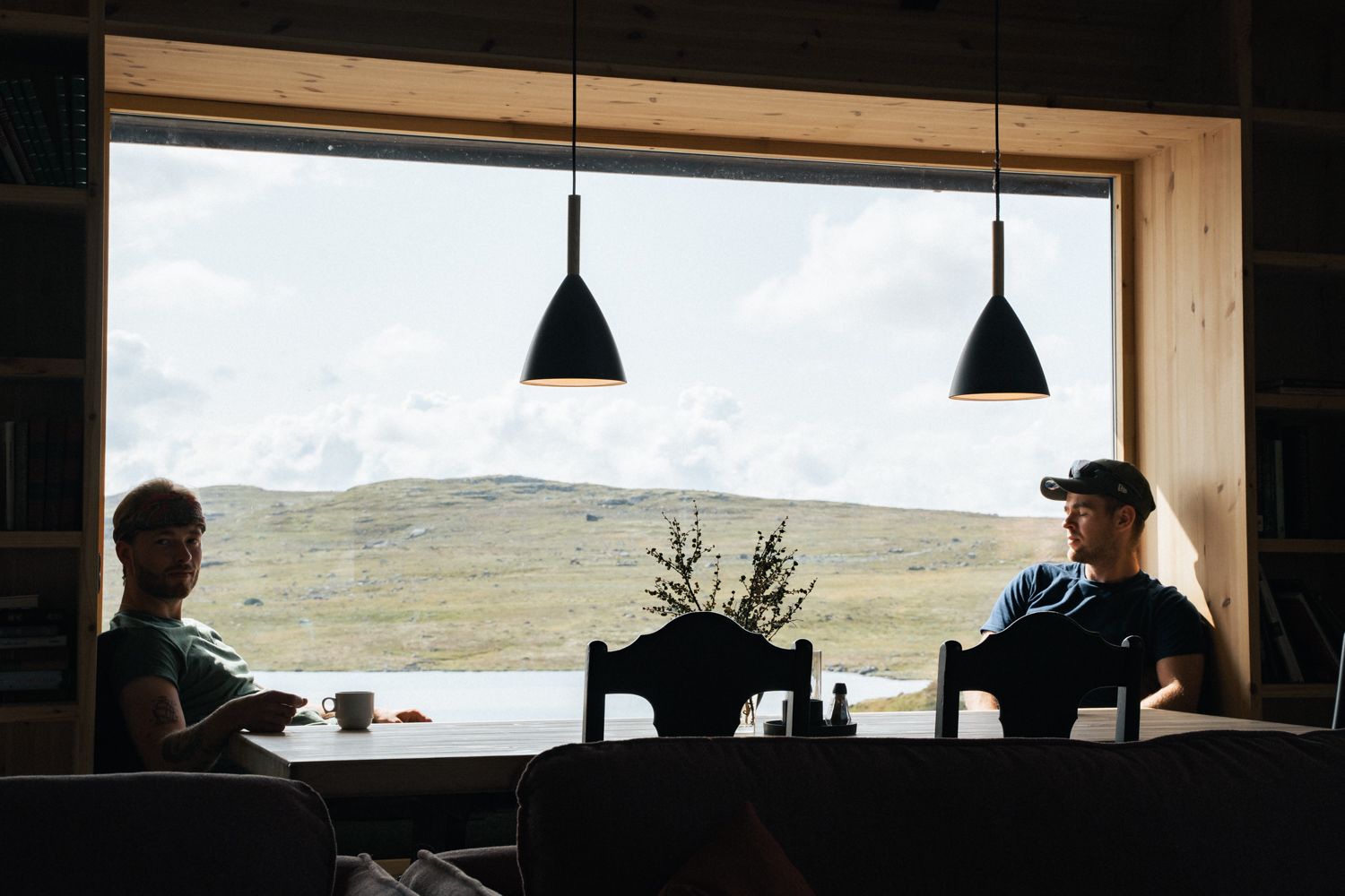Two men sitting by the window in the restaurant.