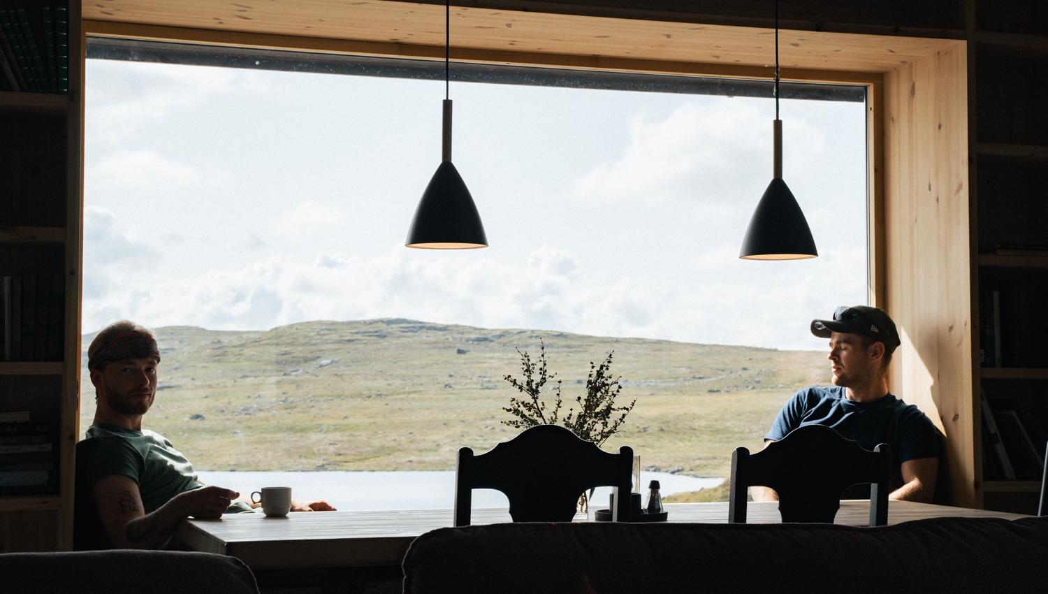 Two men sitting by the window in the restaurant.