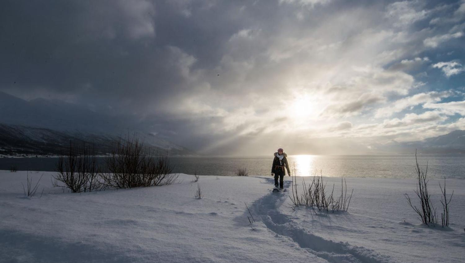 A person with snowshoes on a trail
