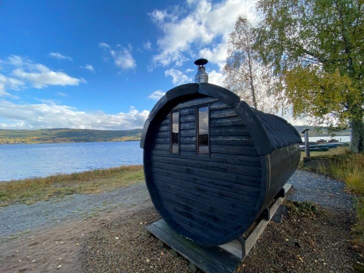 Barrel sauna utside by the lake 