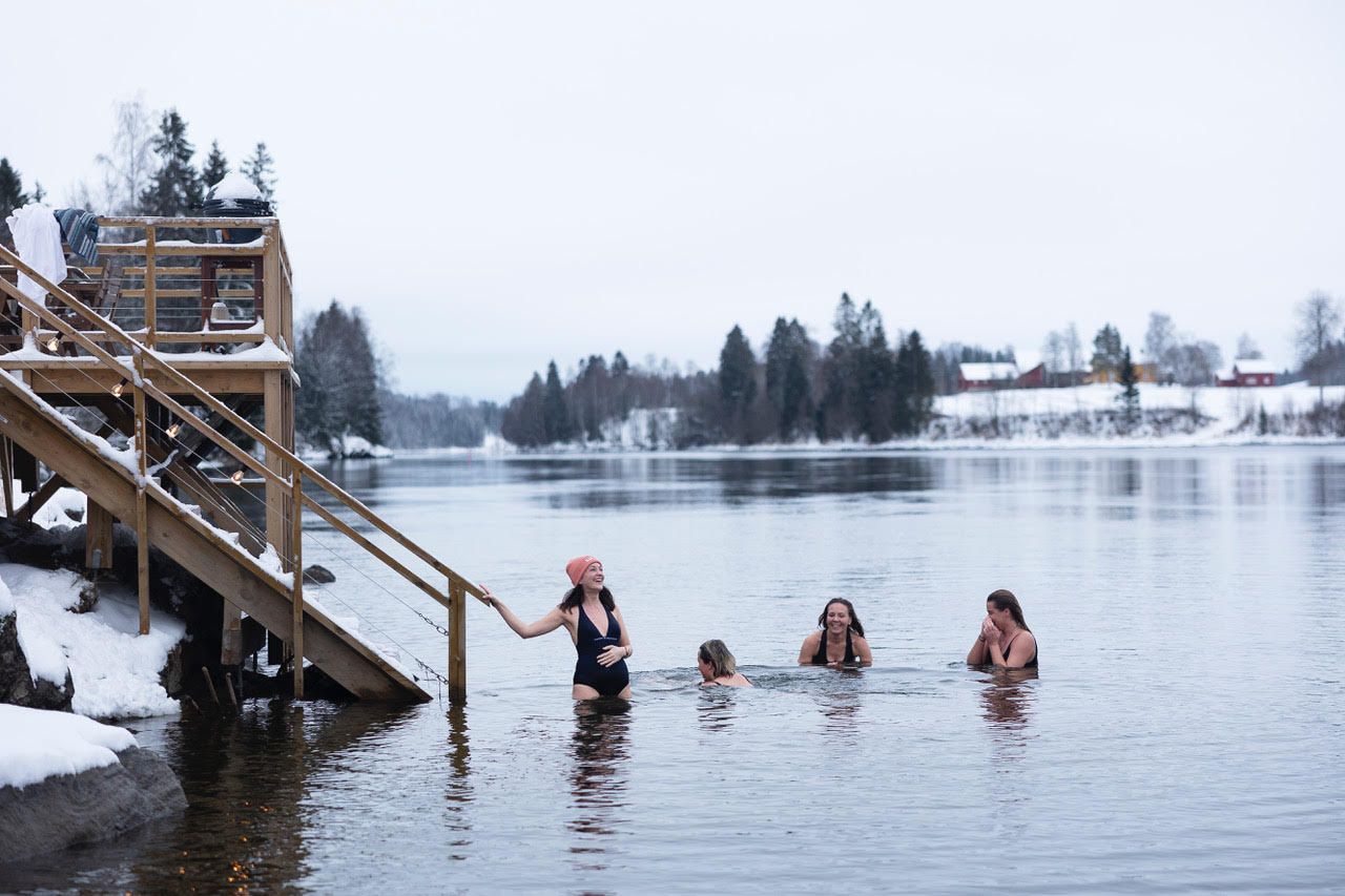 4 women bathing in a river in the winter 
