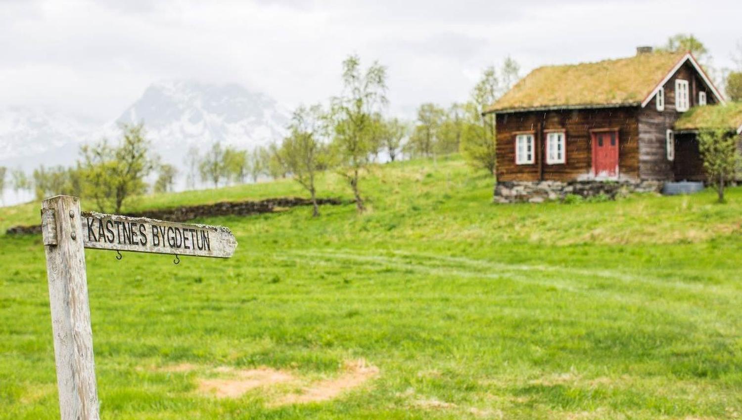 Landscape with a traditional log building.