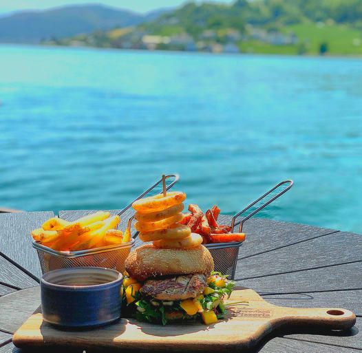 Juicy burger and crispy fries served by the waterfront overlooking the Hardangerfjord.