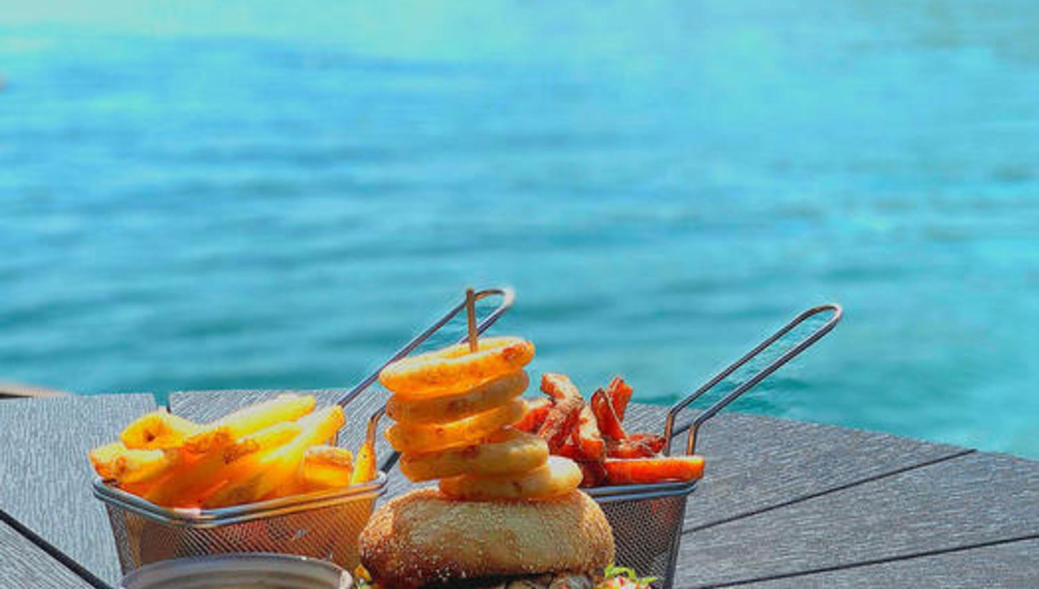 Juicy burger and crispy fries served by the waterfront overlooking the Hardangerfjord.