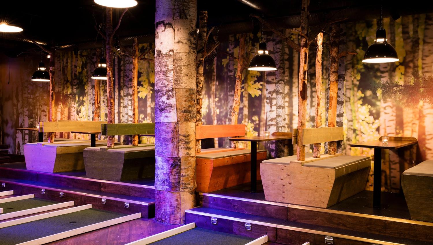 seating area: made of wood with tree trunks and wallpaper with trees as decoration