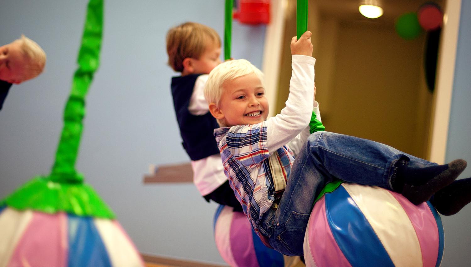Lykkeland, a play centre in Steinkjer - girl on a hanging ball