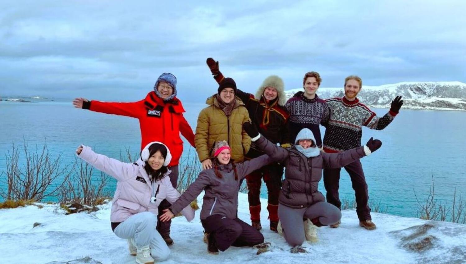 Guests pose for the camera with the fjord in the background.